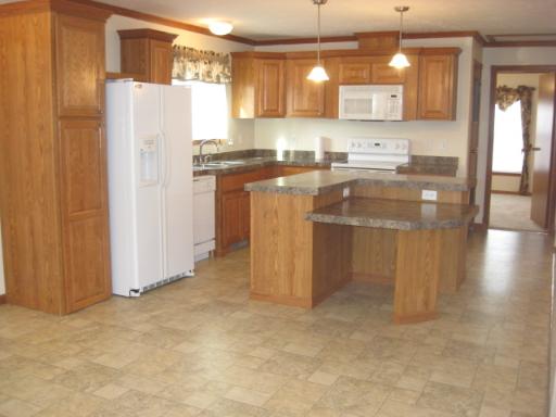407 James Road Elwood, IL 60421 - Photo 2 of 15 a kitchen with a sink a refrigerator and cabinets