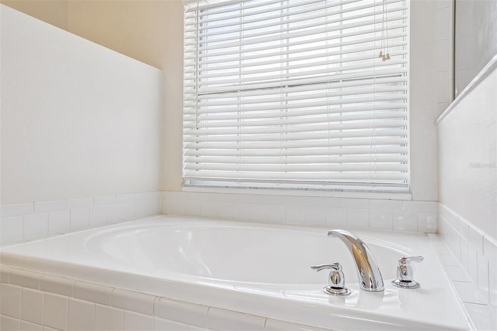 2596 Alclobe Circle Ocoee, FL 34761 - Photo 40 of 70 a bathroom with a bathtub and a window