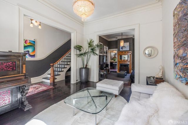 a living room with furniture and a book shelf