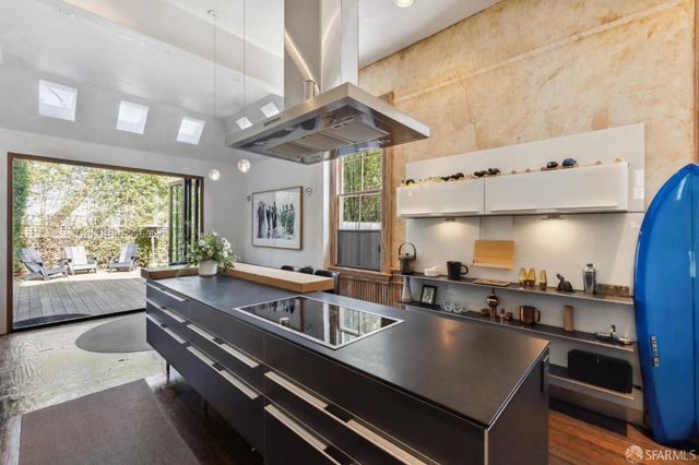 a kitchen with stainless steel appliances granite countertop a sink a stove and a refrigerator