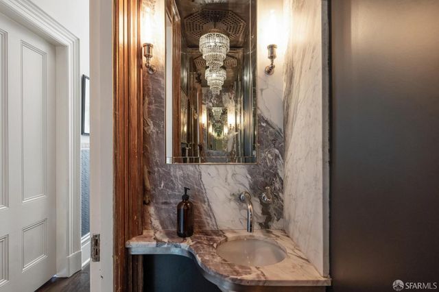 a view of a hallway with wooden floor and closet