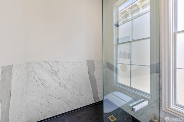 a bed room with a bed and painting on the wall