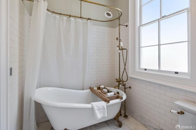 a view of a hallway with wooden floor and closet