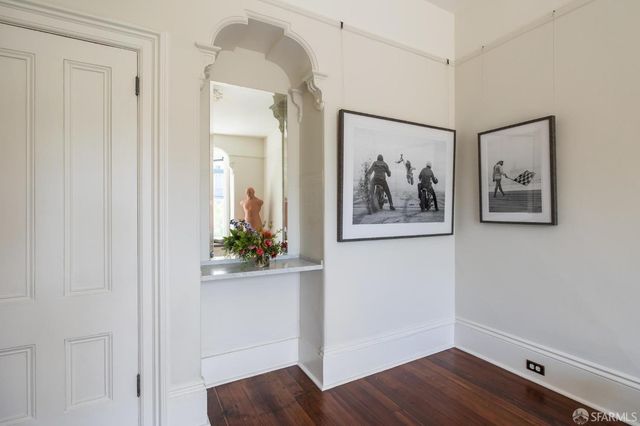 a front view of a house with a tree