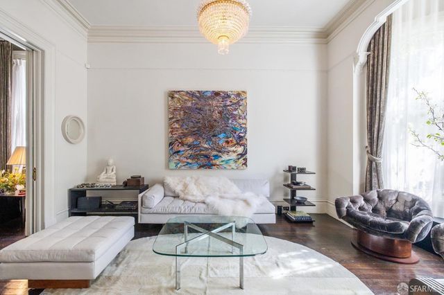a living room with furniture and a chandelier