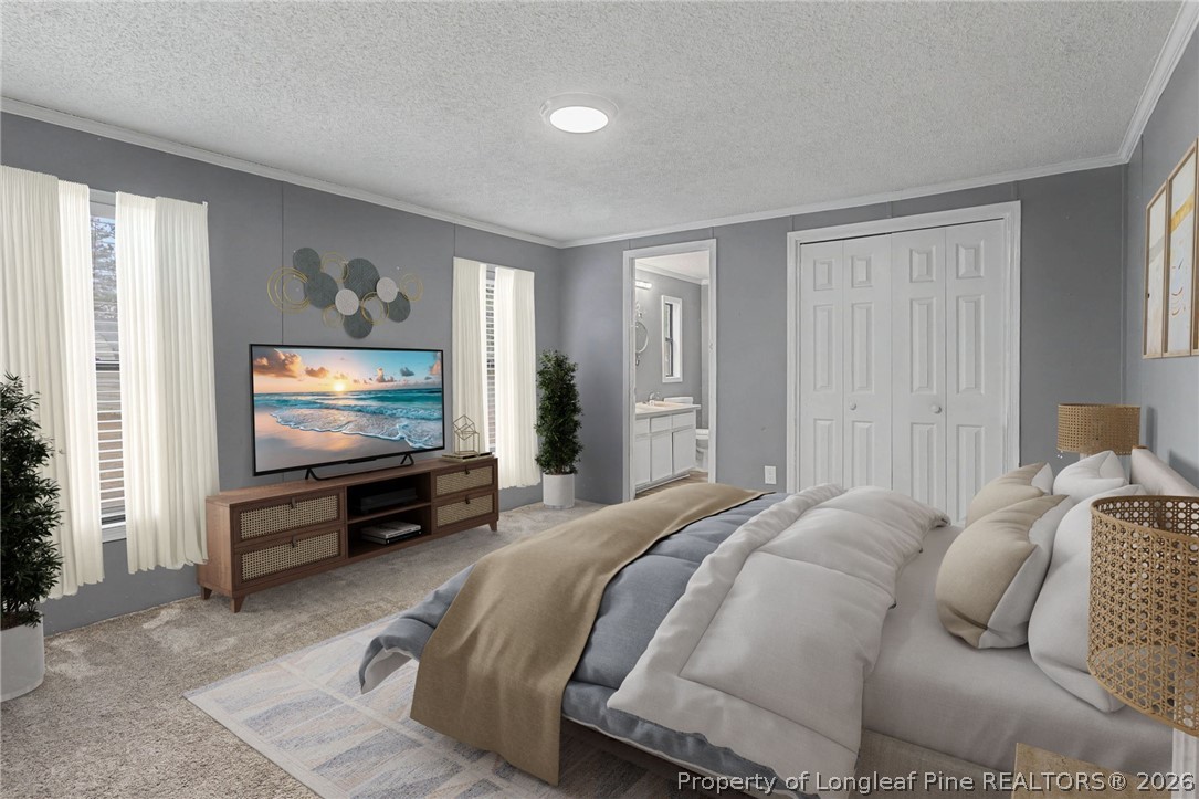 1512 Seabrook School Road Fayetteville, NC 28312 - Photo 5 of 30 a bedroom with a bed and a flat screen tv