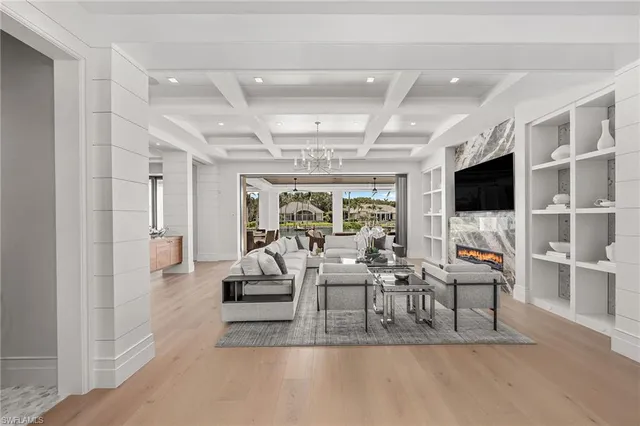 a living room with fireplace furniture and a flat screen tv