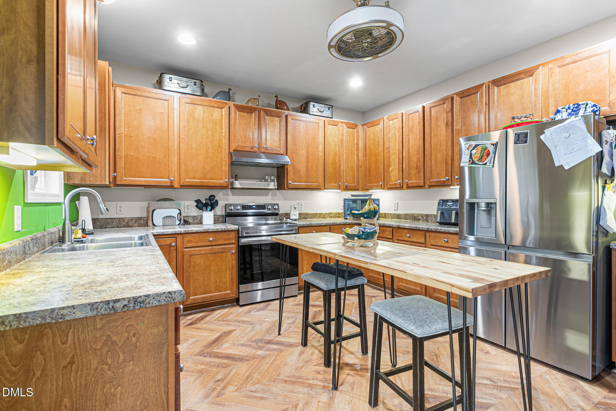 1205 Magnolia Hill Road Garner, NC 27529 - Photo 10 of 41 a kitchen with stainless steel appliances granite countertop a stove top oven a sink a refrigerator and a microwave