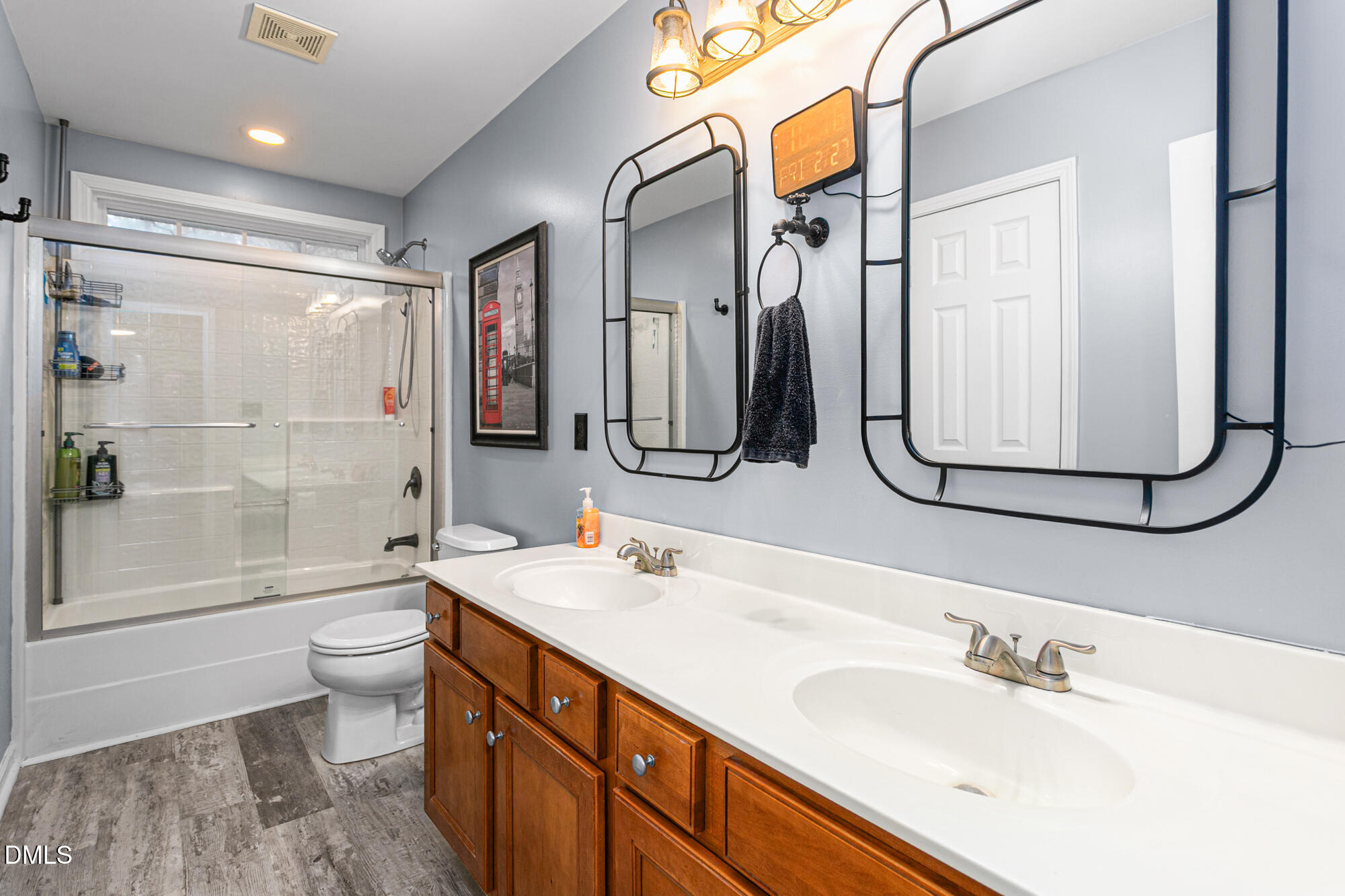 1205 Magnolia Hill Road Garner, NC 27529 - Photo 26 of 41 a bathroom with a double vanity sink toilet mirror and shower