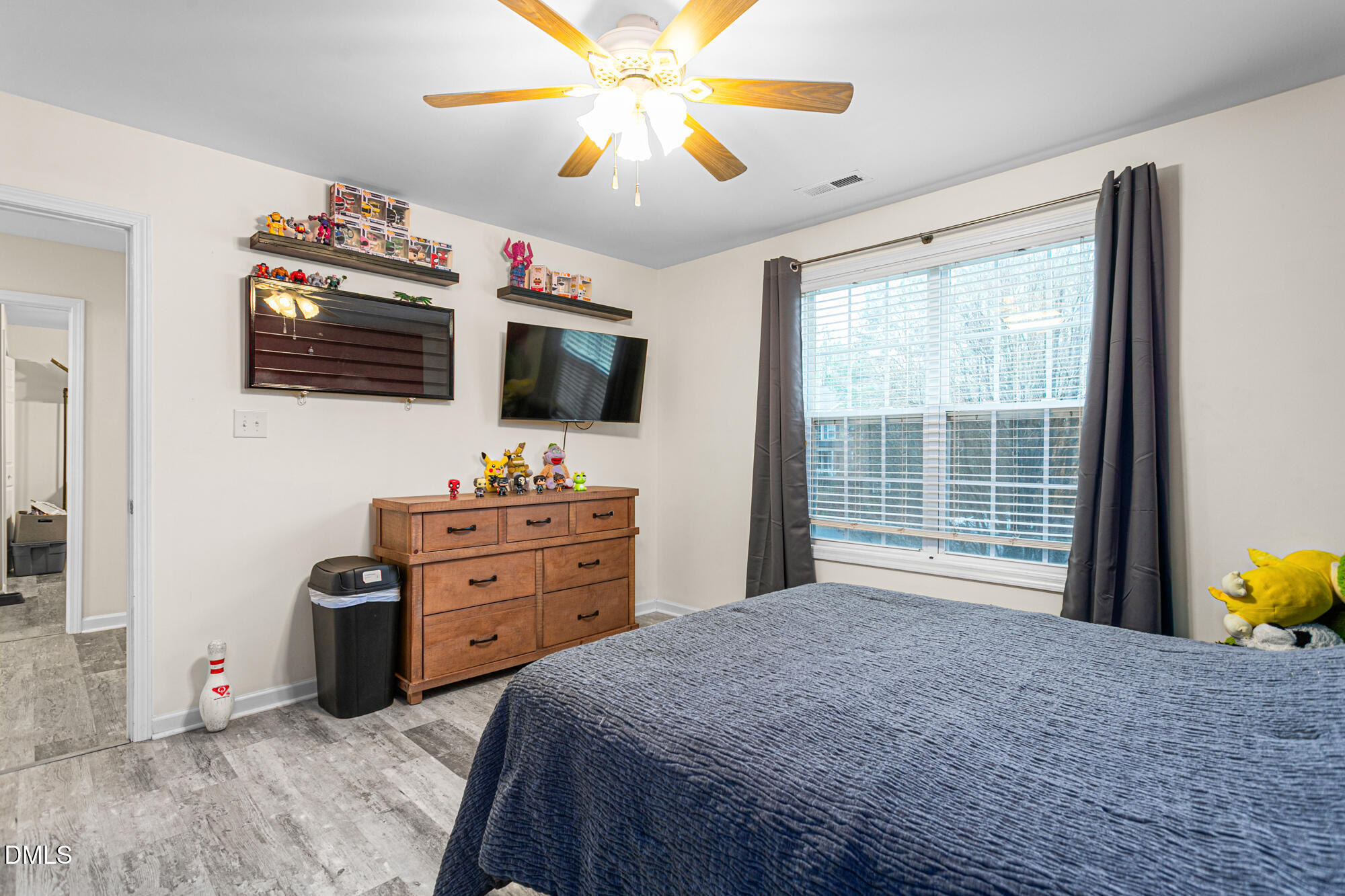 1205 Magnolia Hill Road Garner, NC 27529 - Photo 28 of 41 a bedroom with a bed and a flat screen tv