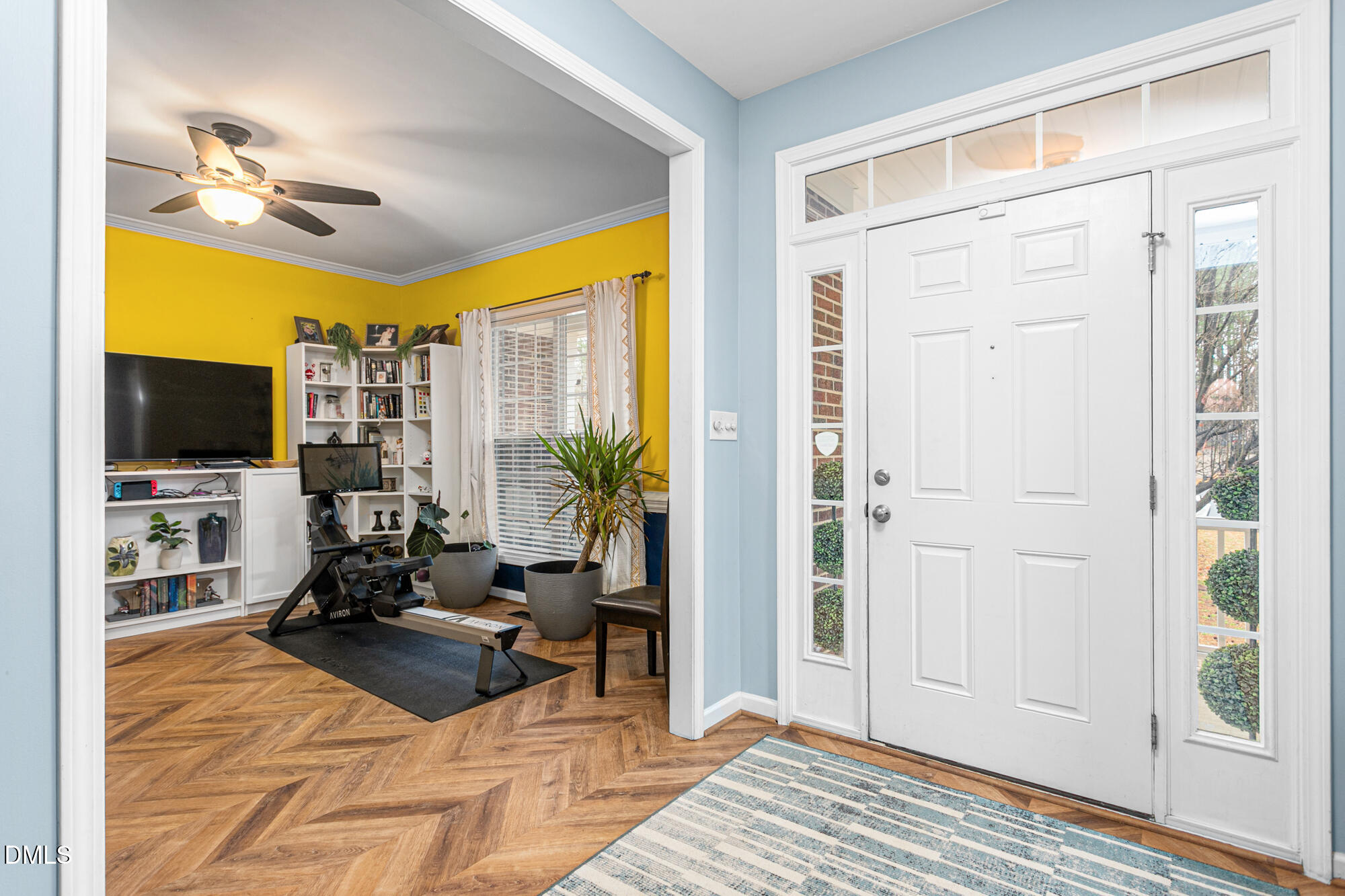 1205 Magnolia Hill Road Garner, NC 27529 - Photo 4 of 41 a living room with furniture a flat screen tv and a floor to ceiling window