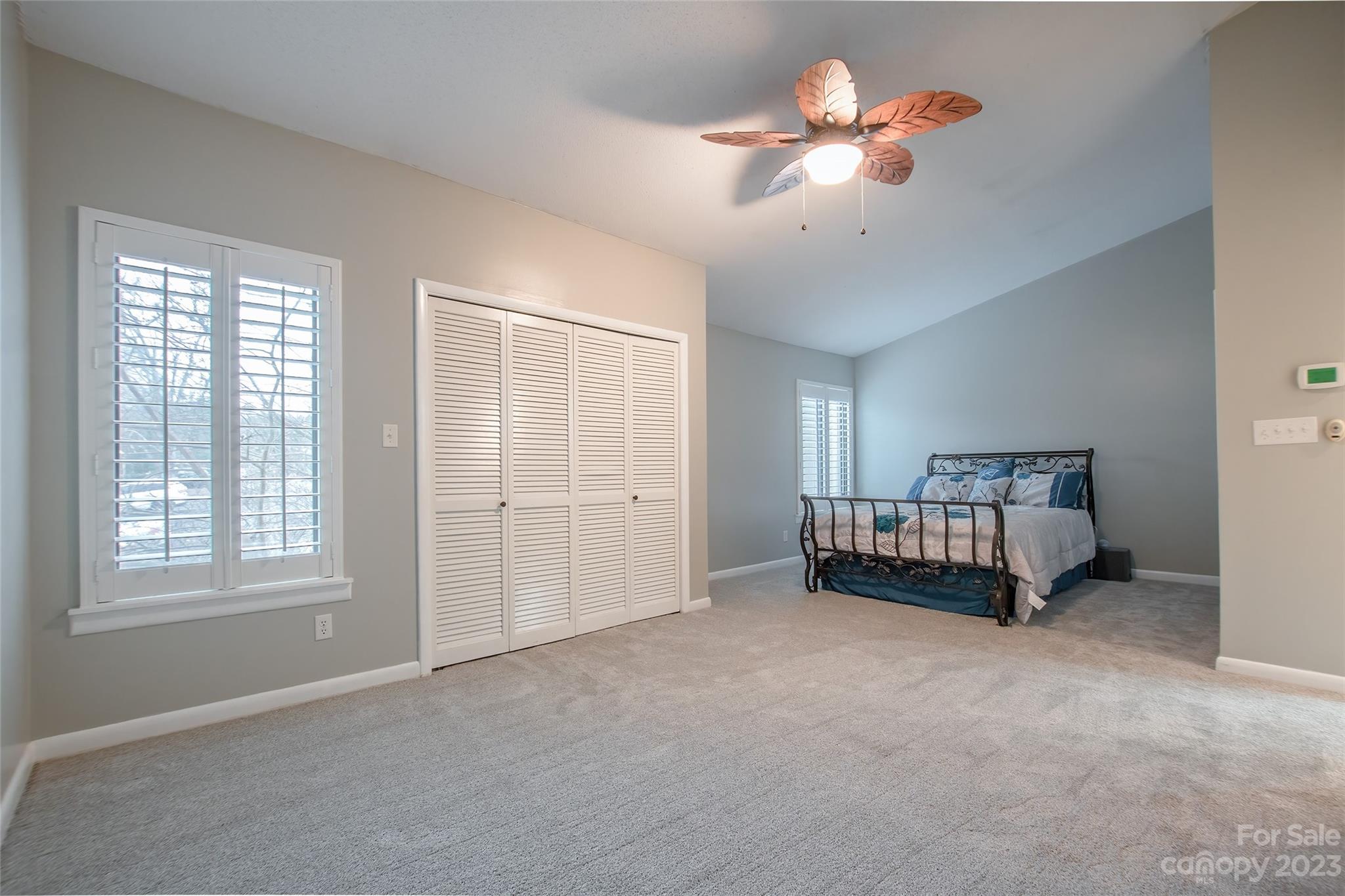 93 Ridgeport Road Lake Wylie, SC 29710 - Photo 13 of 38 a spacious bedroom with a bed and a chandelier