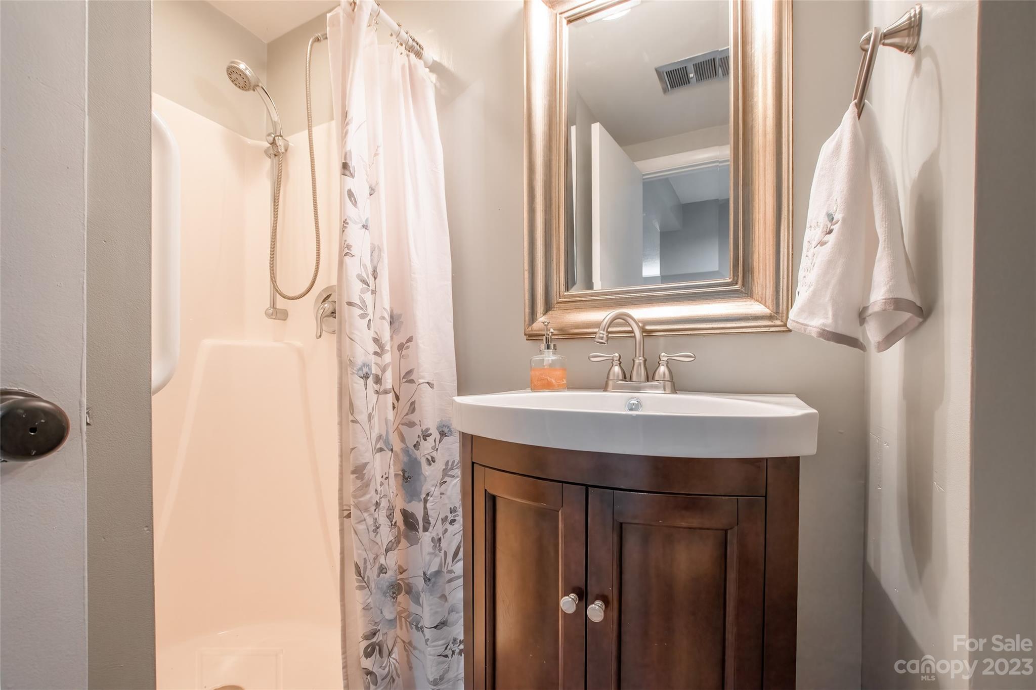 93 Ridgeport Road Lake Wylie, SC 29710 - Photo 26 of 38 a bathroom with a sink a mirror a vanity and a shower