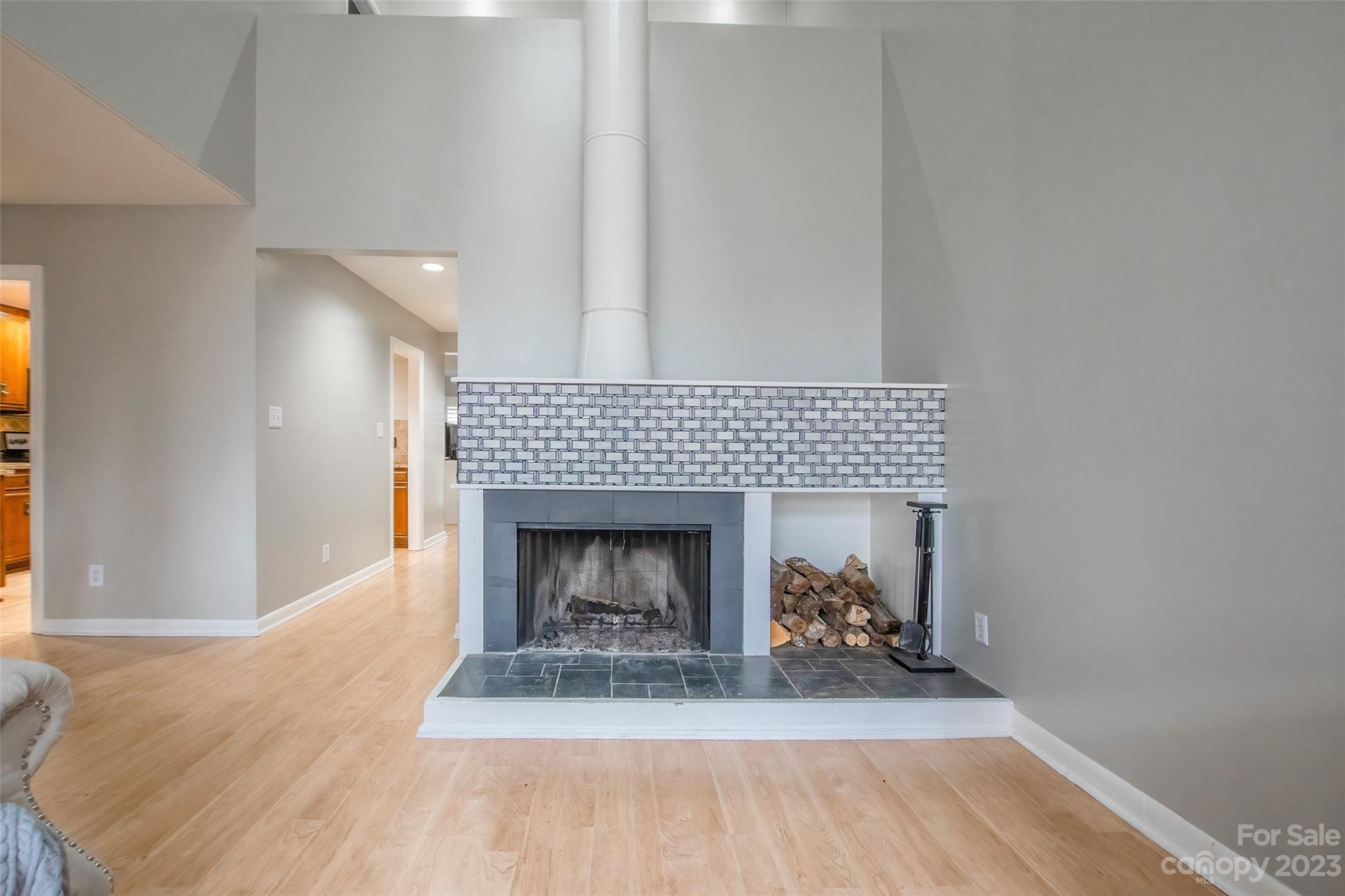 93 Ridgeport Road Lake Wylie, SC 29710 - Photo 5 of 38 a living room with a fireplace and a wooden floor