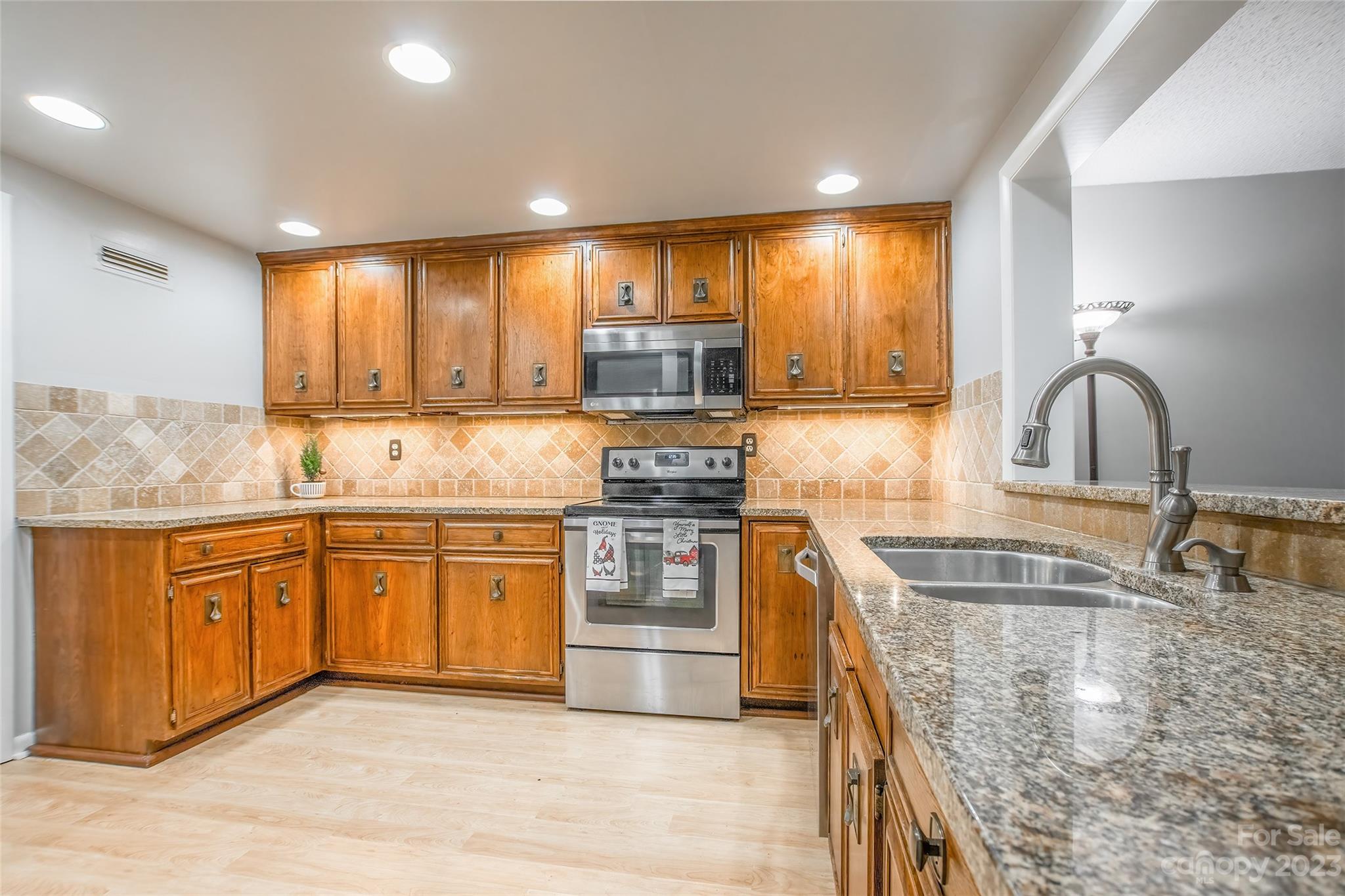 93 Ridgeport Road Lake Wylie, SC 29710 - Photo 6 of 38 a kitchen with stainless steel appliances granite countertop a sink stove and cabinets
