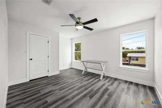 wooden floor in an empty room with a window