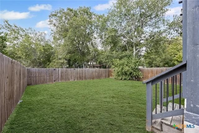 a view of a backyard with a trees