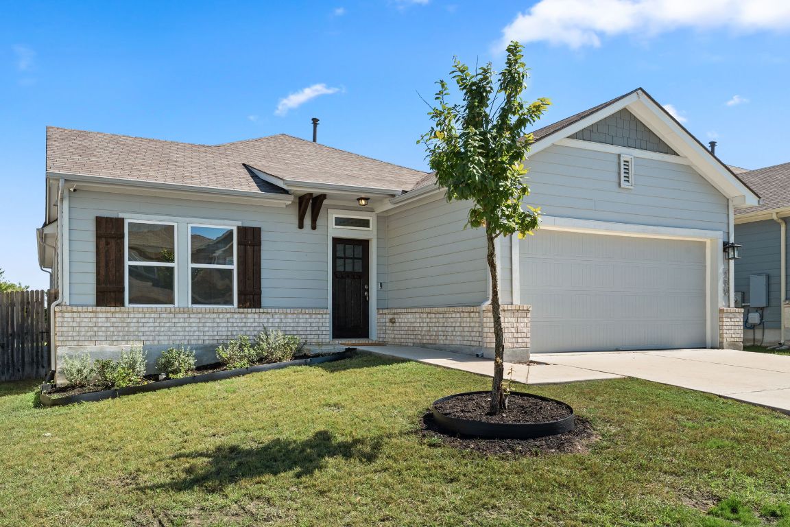 489 Bridgestone Way Buda, TX 78610 - Photo 1 of 1 a front view of a house with a yard