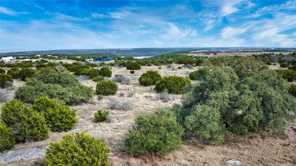 an aerial view of a houses with a yard