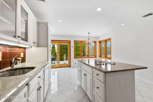 a kitchen with stainless steel appliances granite countertop a stove and cabinets
