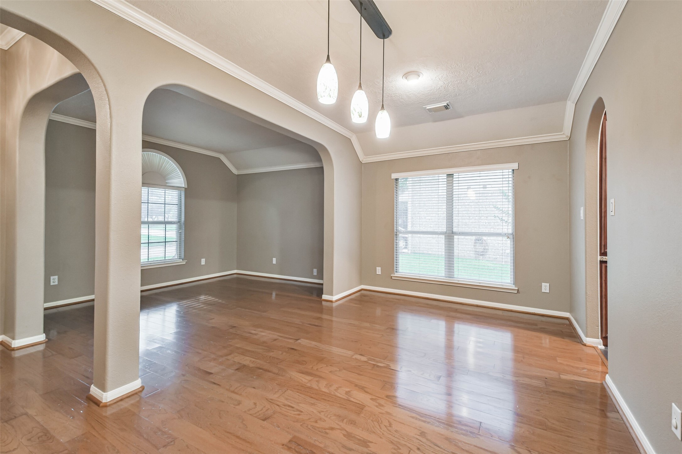 20942 Wind Field Lane Spring, TX 77379 - Photo 6 of 46 a view of an empty room with wooden floor and a window