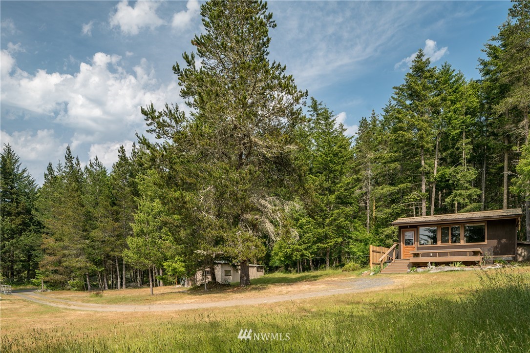 611 Shark Reef Road Lopez Island, WA 98261 - Photo 1 of 13 a view of a house with yard and sitting area