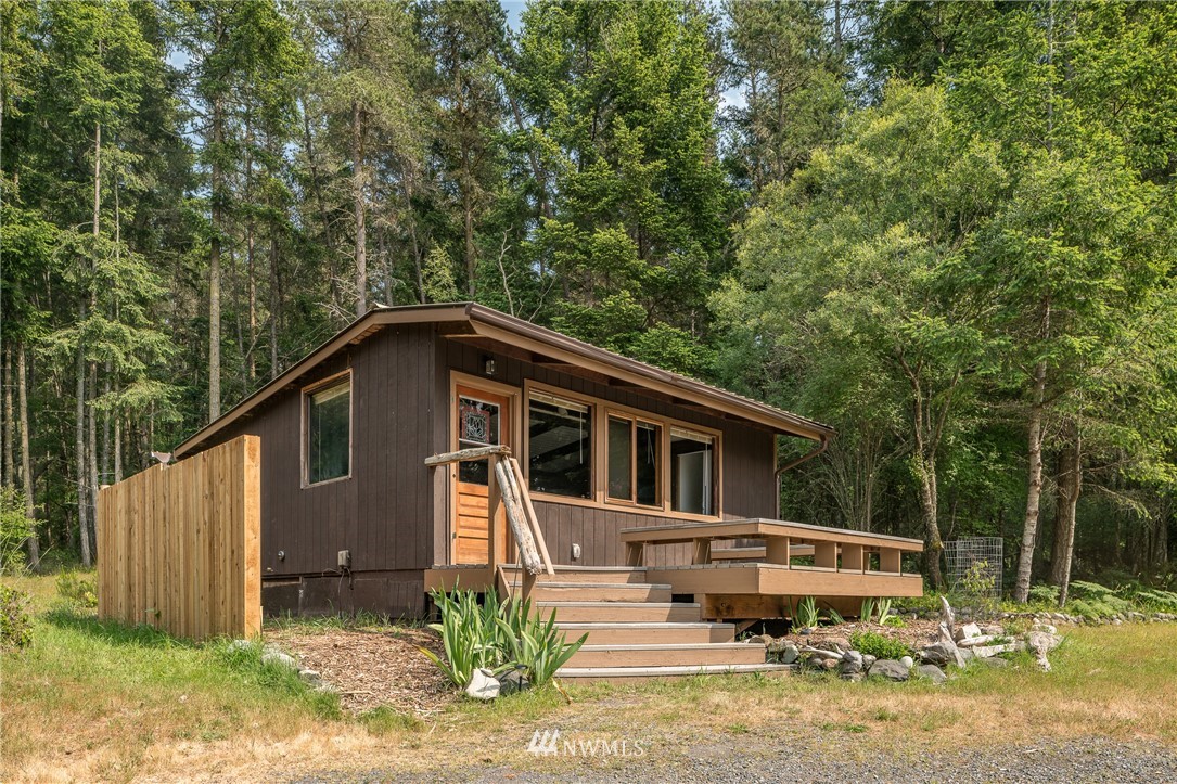 611 Shark Reef Road Lopez Island, WA 98261 - Photo 2 of 13 a backyard of a house with yard barbeque oven and outdoor seating