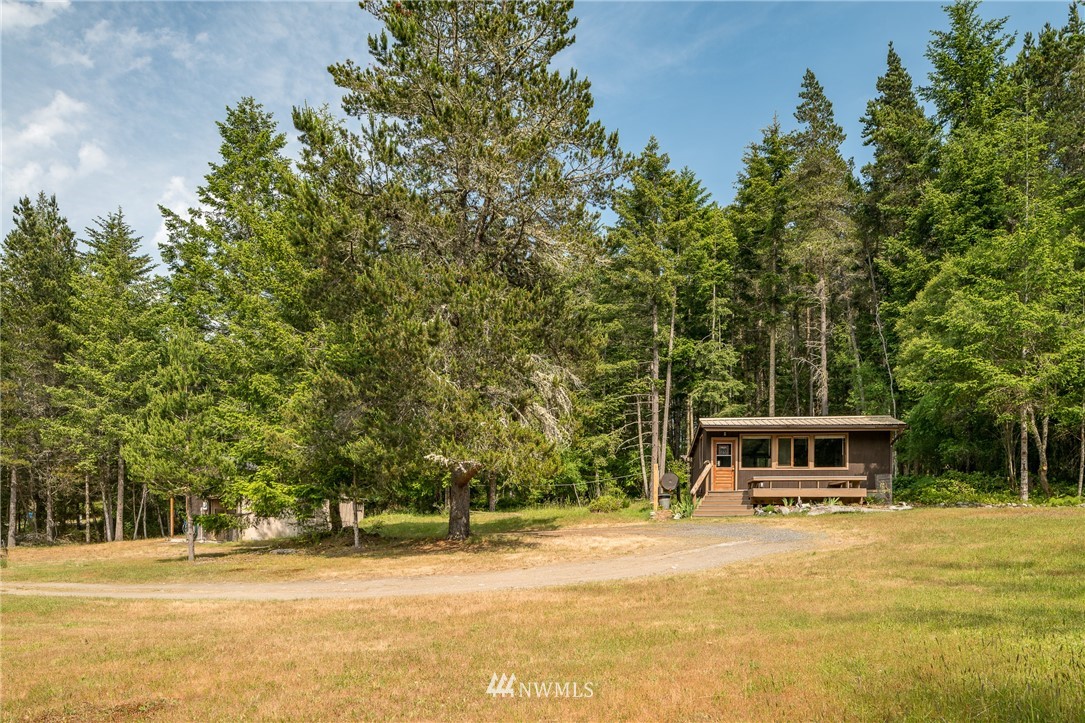 611 Shark Reef Road Lopez Island, WA 98261 - Photo 3 of 13 a front view of a house with a yard