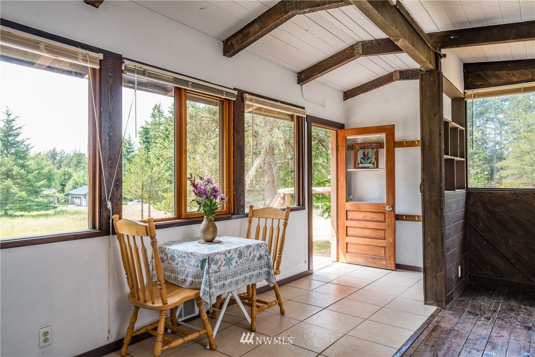 611 Shark Reef Road Lopez Island, WA 98261 - Photo 6 of 13 a dining room with furniture and large windows