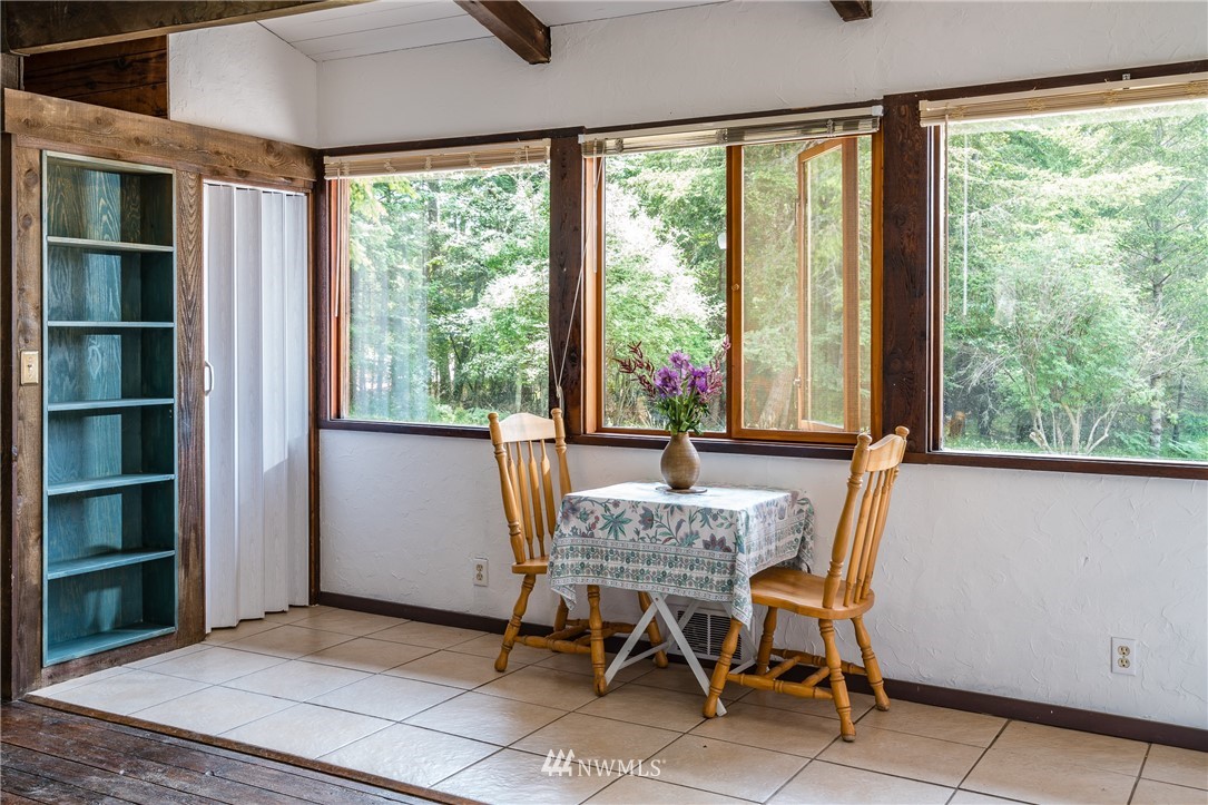611 Shark Reef Road Lopez Island, WA 98261 - Photo 10 of 13 a view of a dining room with furniture and a window