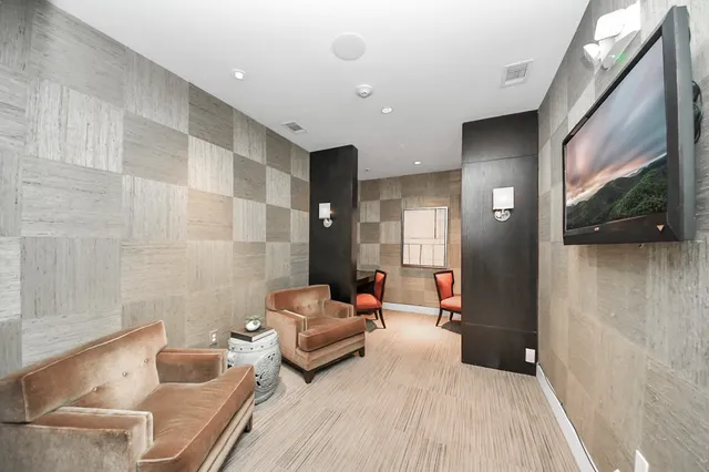 a view of an empty room with a fireplace and windows