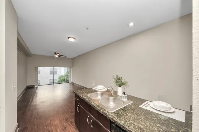 a view of a livingroom with a ceiling fan and window