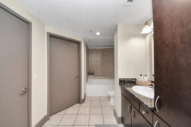 an empty room with closet and a ceiling fan