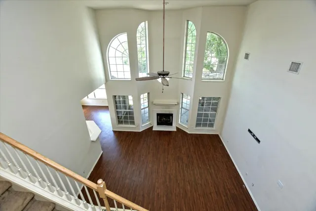 a view of hall way with furniture and wooden floor