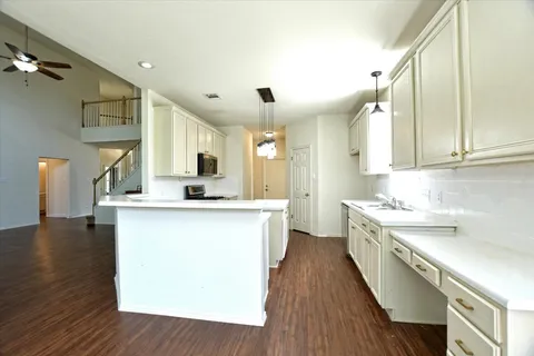 a kitchen with a sink and wooden cabinets