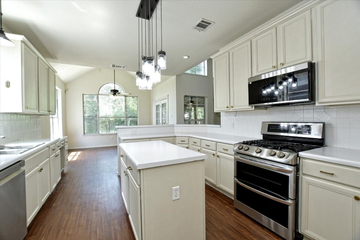 301 Gulfstream Drive Georgetown, TX 78626 - Photo 16 of 35 a kitchen with granite countertop a stove a sink and a microwave