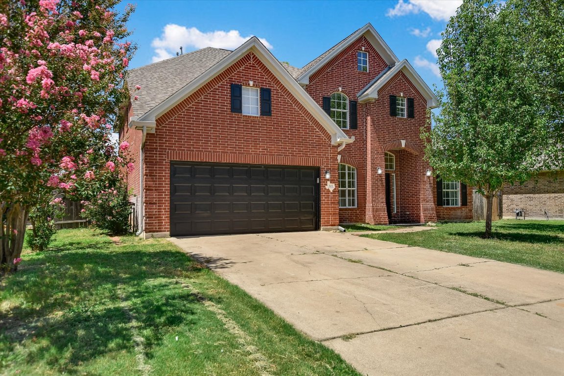 301 Gulfstream Drive Georgetown, TX 78626 - Photo 2 of 35 a front view of a house with a yard and garage
