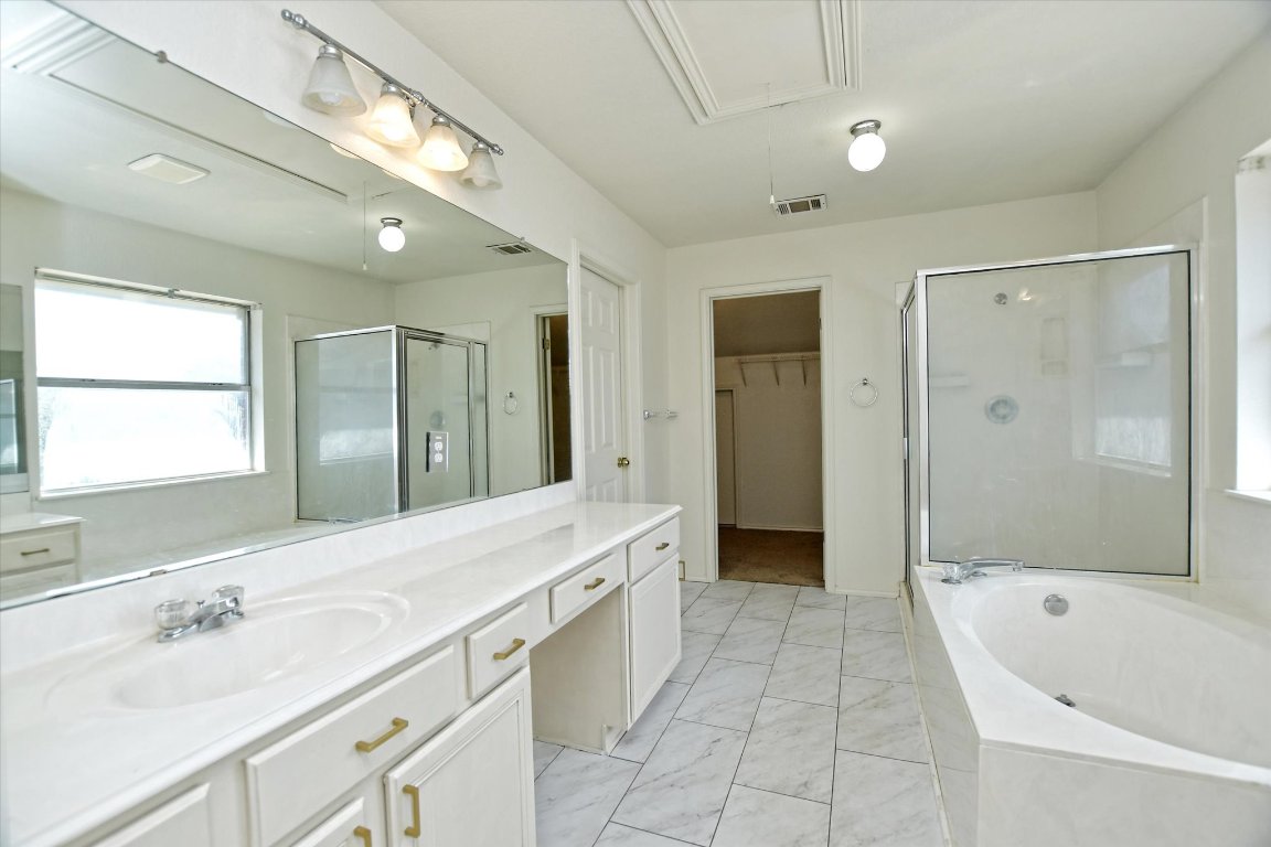 301 Gulfstream Drive Georgetown, TX 78626 - Photo 24 of 35 a spacious bathroom with a tub sink shower and mirror
