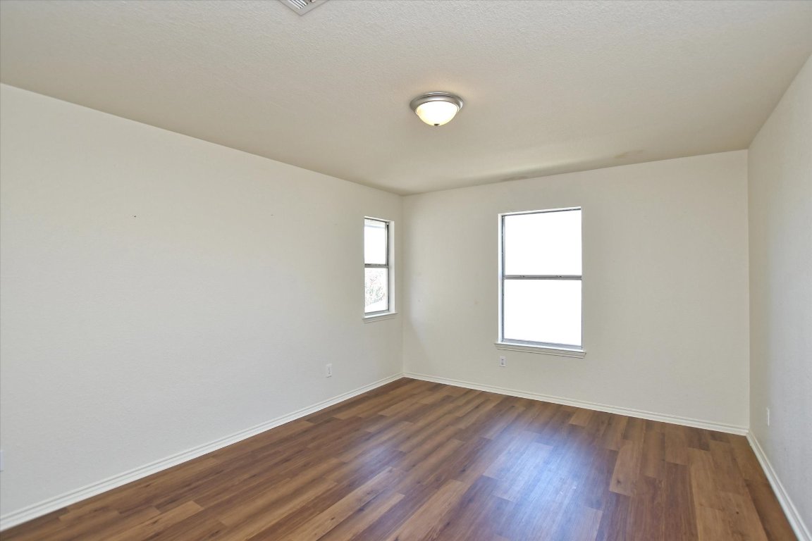 301 Gulfstream Drive Georgetown, TX 78626 - Photo 28 of 35 an empty room with wooden floor and windows