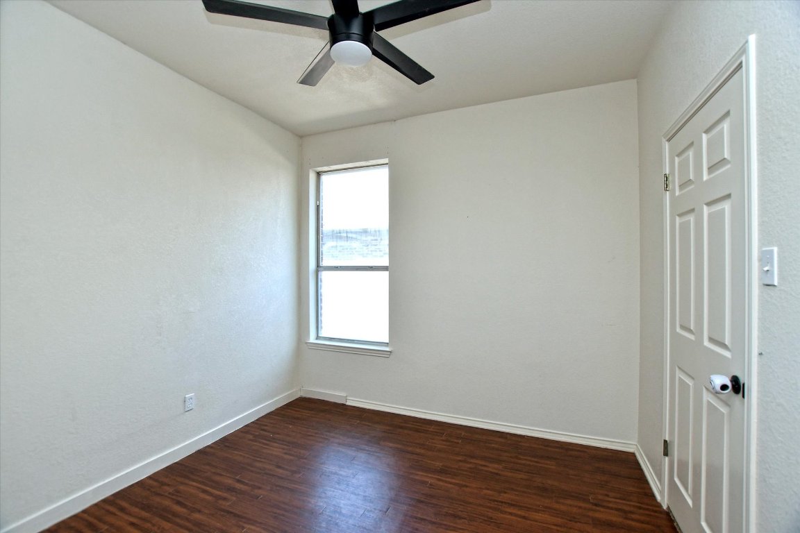 301 Gulfstream Drive Georgetown, TX 78626 - Photo 30 of 35 an empty room with wooden floor fan and windows