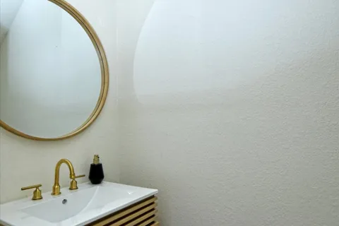 a bathroom with a sink and mirror
