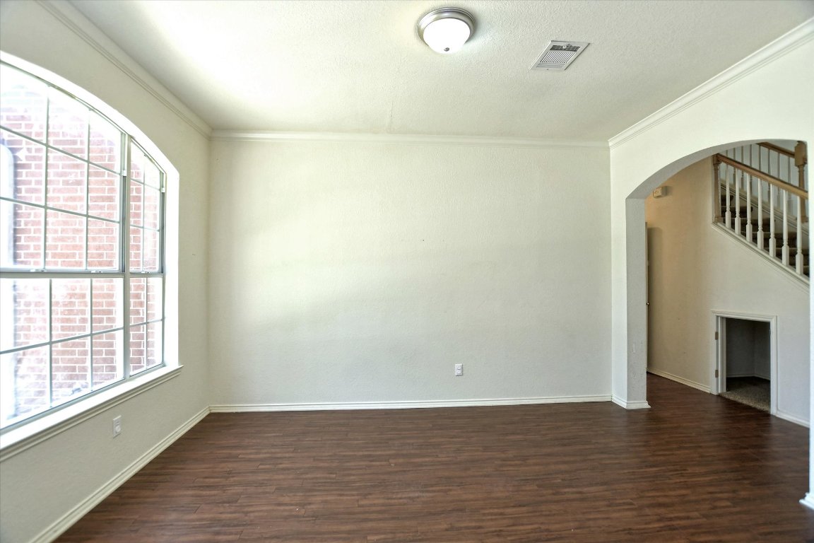 301 Gulfstream Drive Georgetown, TX 78626 - Photo 7 of 35 wooden floor in an empty room with a window
