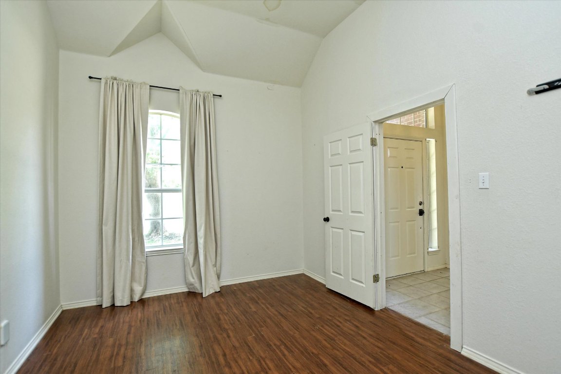 301 Gulfstream Drive Georgetown, TX 78626 - Photo 8 of 35 an empty room with wooden floor and windows