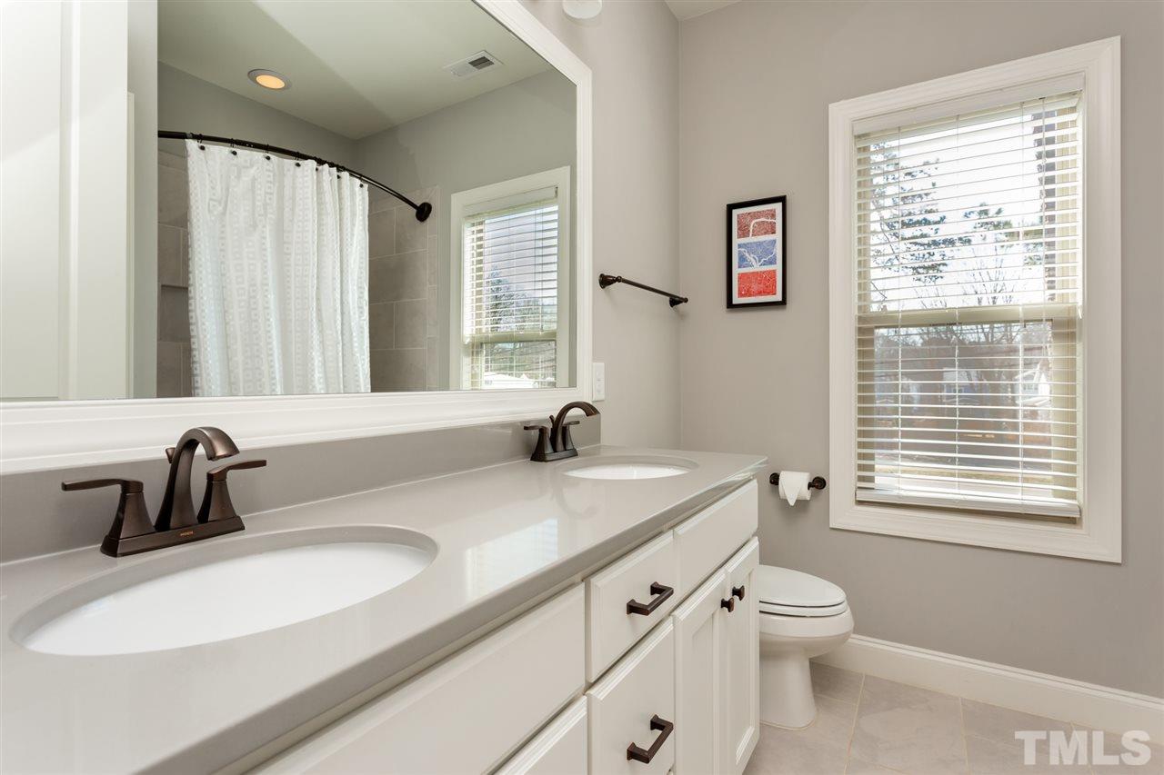 101 Pineland Circle Raleigh, NC 27606 - Photo 16 of 21 a bathroom with a sink a toilet and a window