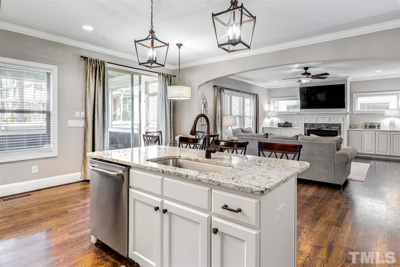 101 Pineland Circle Raleigh, NC 27606 - Photo 3 of 21 a kitchen with stainless steel appliances granite countertop a sink dishwasher a dining table and chairs with wooden floor
