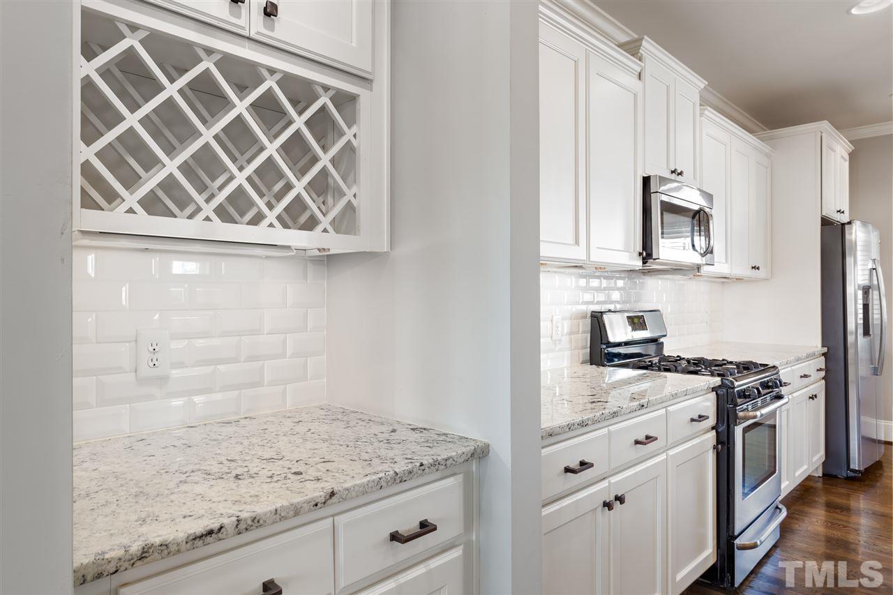 101 Pineland Circle Raleigh, NC 27606 - Photo 4 of 21 a kitchen with granite countertop a sink cabinets and stainless steel appliances