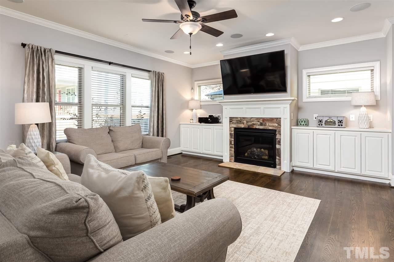 101 Pineland Circle Raleigh, NC 27606 - Photo 6 of 21 a living room with furniture a fireplace and a flat screen tv