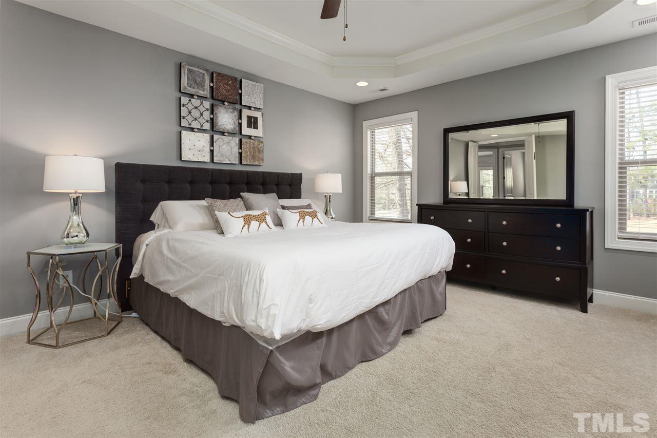 101 Pineland Circle Raleigh, NC 27606 - Photo 10 of 21 a bedroom with a bed a dresser and painting on the wall
