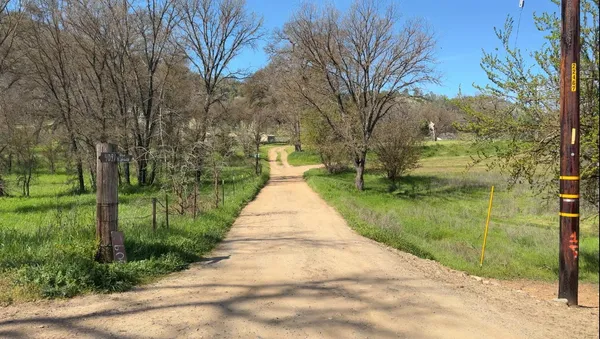 a view of a road with a yard