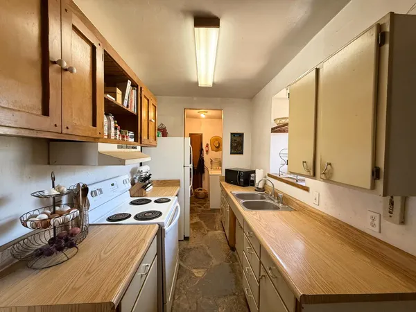 a kitchen with a sink stove and cabinets
